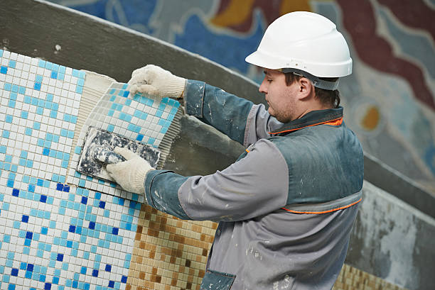 industrial tiler builder worker installing floor tile at repair renovation work industrial tiler builder worker installing floor tile at repair renovation work